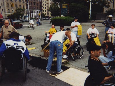 A man in a wheelchair unable to get onto a curb