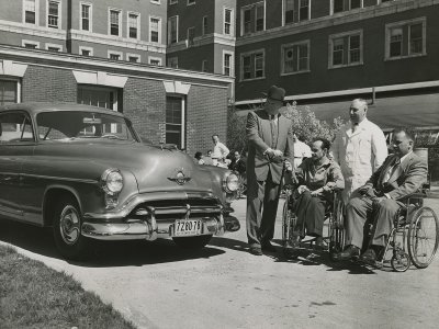 Person using hand controls in a car