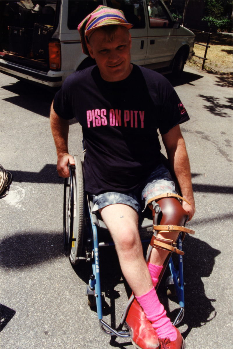 Musician Johnny Crescendo wearing a t-shirt that reads "Piss on Pity."