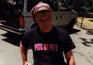 Musician Johnny Crescendo wearing a t-shirt that reads "Piss on Pity."