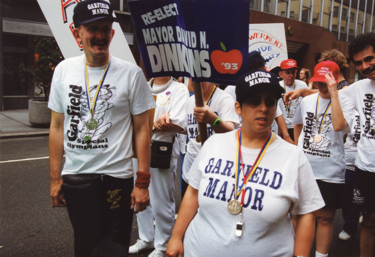 A group of activists stands side-by-side across a city street during a historic march.