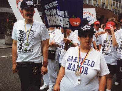 A group of activists stands side-by-side across a city street during a historic march.
