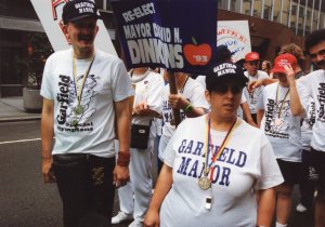A group of activists stands side-by-side across a city street during a historic march.