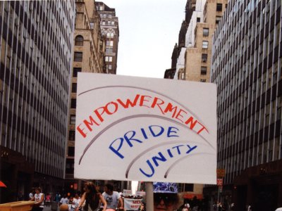 A marcher walks down a New York City street holding a sign